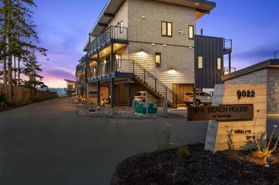 a large building with a sign in front of it at Beachfront Villa #14 at The Beach House in Campbell River