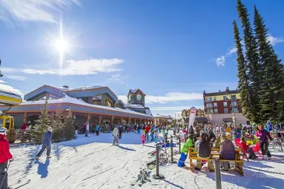 a group of people standing around in a ski resort at Luxury Aspens 2 Bdrm Condo with Best Views in Big White