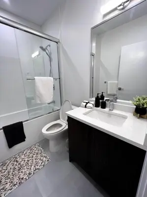 a bathroom with a sink and a toilet and a shower at Grand Boulevard Basement Suite in North Vancouver