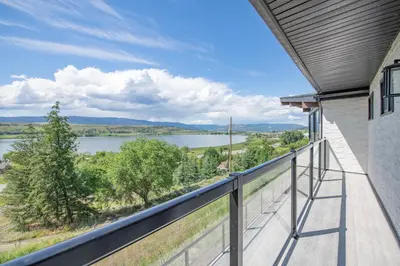 a balcony with a view of a lake at Lakeviews, big yard/deck, minutes to Silver Star/Golf/Wineries. in Vernon