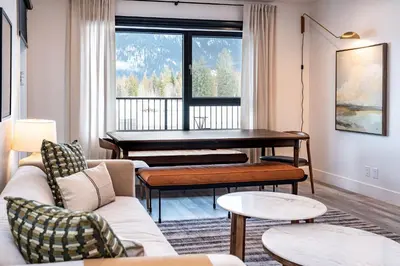 a living room with a piano and a couch at Escape to Revy - Beautifully Designed Condo in Revelstoke