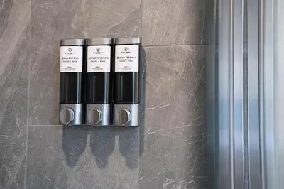 a group of three bottles of lipstick on a wall at Escape to Revy - Beautifully Designed Condo in Revelstoke