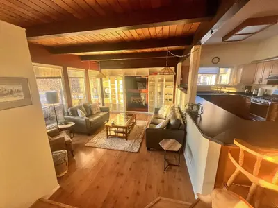 a living room with a couch and a table at Whitehorse Home on the River in Whitehorse