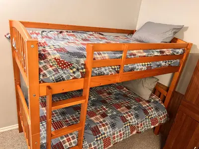 two bunk beds in a room with a bed at Whitehorse Home on the River in Whitehorse