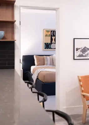 a bedroom with a bed in a room with white walls at Snow & Swing Getaway - Three Bedrooms with Hot Tub (Stay Revy) in Revelstoke