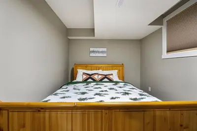 a bedroom with a wooden bed in a room at Newly renovated 2 bedroom basement suite in Calgary