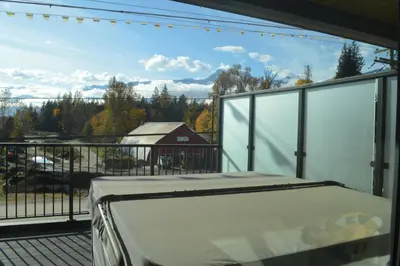 a balcony with a view of a barn at Stokeside Serenity in Revelstoke