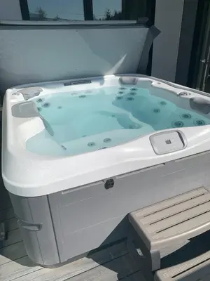 a white bath tub sitting in a room at Stokeside Serenity in Revelstoke