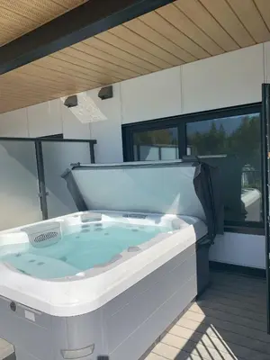 a jacuzzi tub on the deck of a house at Stokeside Serenity in Revelstoke