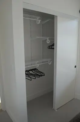a walk in closet with white walls and shelves at Stokeside Serenity in Revelstoke