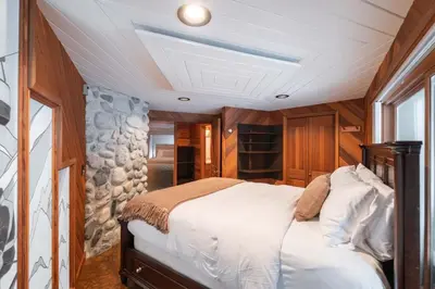 a bedroom with a large bed in a room at Snowridge Chalet by Outpost Whistler in Whistler