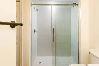 a shower with a glass door in a bathroom at Alpine Timber Luxury Chalet w/Hot Tub in Big White