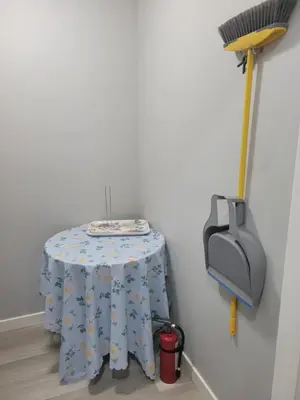 a table in a corner with a table cloth on it at Brand New 2 Bedroom Basement Suite with Wifi in Edmonton