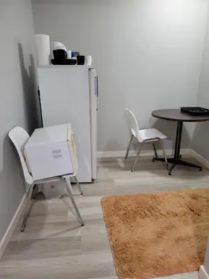 a dining room with a table and a table and chairs at Brand New 2 Bedroom Basement Suite with Wifi in Edmonton