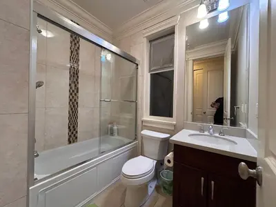 a bathroom with a toilet and a shower and a sink at Cozy and Private Suite in Richmond in Richmond