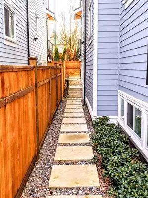 a backyard with a fence next to a house at 2 Bed Apartment Free Parking Central Location in Vancouver