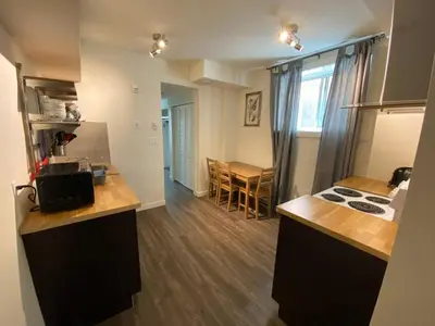 a kitchen with a stove and a counter top at Dt 1Bed 1bath Cozy Suite 8 Min Walk To Arena in Edmonton