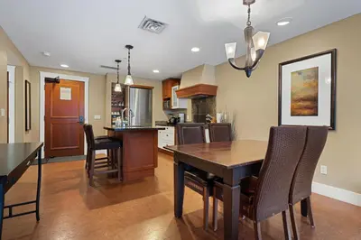 a kitchen and dining room with a table and chairs at Adventurer's Escape~ Mountain Luxury Resort in Canmore