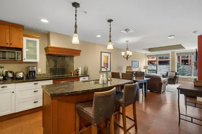 a kitchen with a large island in the middle of a room at Adventurer's Escape~ Mountain Luxury Resort in Canmore