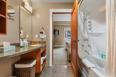 a bathroom with a shower and a sink at Adventurer's Escape~ Mountain Luxury Resort in Canmore