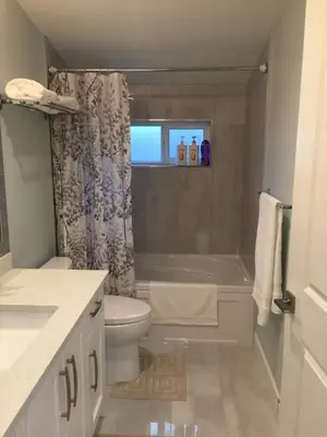 a bathroom with a tub and a toilet and a shower at Arbutus summer house in Vancouver
