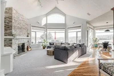 a living room with a couch and a fireplace at Emerald Bay Luxury Retreat with Hot Tub in Calgary