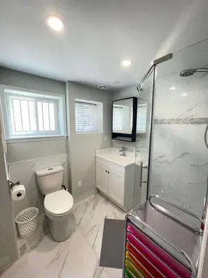 a bathroom with a toilet and a shower at Arbutus violet room in Vancouver