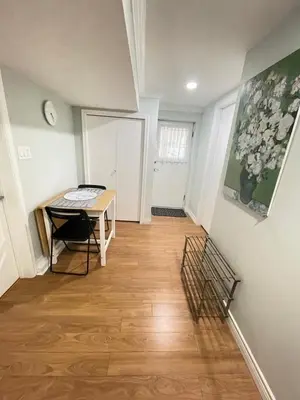 a hallway with a desk and a table in a room at Arbutus Jasmine room in Vancouver