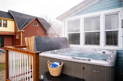a hot tub on the deck of a house at Downtown Home Private Hot Tub Walkable Location in Revelstoke