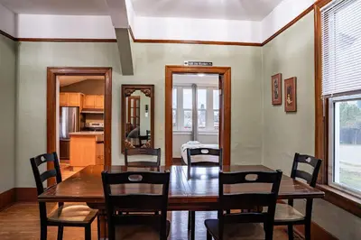 a dining room with a wooden table and chairs at Downtown Home Private Hot Tub Walkable Location in Revelstoke