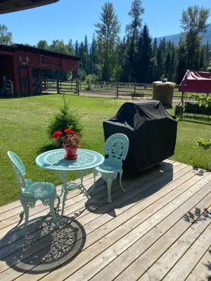 a table and chairs on a deck with a tent at 1868 Noble Cottage in Clearwater