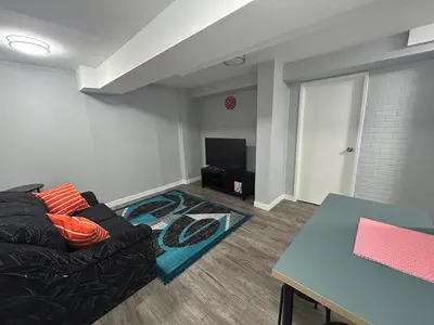 a living room with a couch and a table at Cute Highlandpark (Lower A Unit) in Calgary