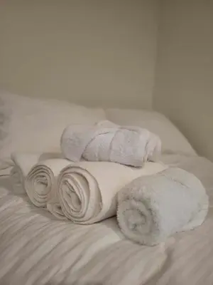 a pile of towels on top of a bed at River Safari Lodge in Blue River