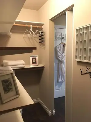 a hallway with a closet with a robe in it at Whitehorse Wonder in Whitehorse