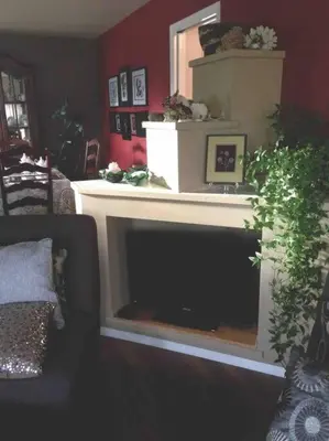 a living room with a fireplace with a mirror at Whitehorse Wonder in Whitehorse