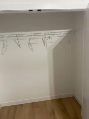 a white room with a shelf on a wall at Modern 2Bedroom suite in SW Edmonton close to Edmonton International Airport in Edmonton