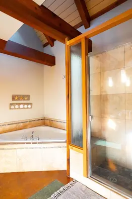 a large bathroom with a tub and a shower at Waterfront Condo in Ucluelet in Ucluelet