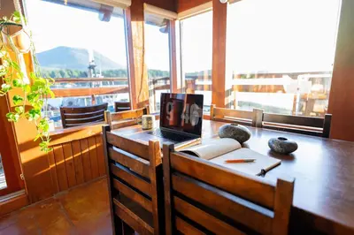 a desk with a laptop computer on top of a table at Waterfront Condo in Ucluelet in Ucluelet