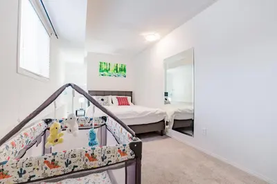 a bedroom with a bunk bed and a staircase at Walkout Basement Suite, 2 BDR 4BD, Bright and Spacious in Calgary