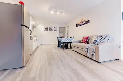 a living room with a couch and a table at Walkout Basement Suite, 2 BDR 4BD, Bright and Spacious in Calgary