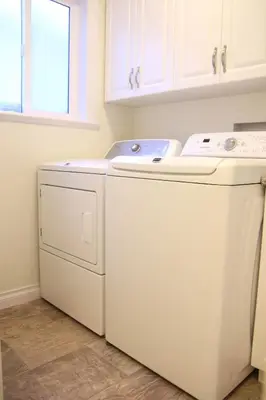 a white washer and dryer in a laundry room at A private suite in Port Moody in Port Moody