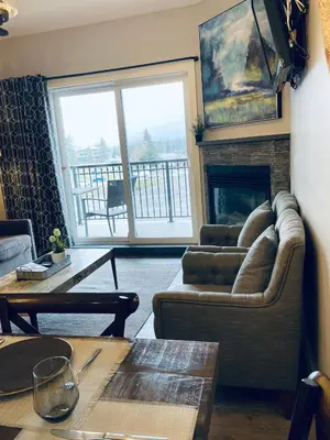 a living room with a couch and a fireplace at Family friendly 2BR/2BA condo - Views & Location!! in Canmore