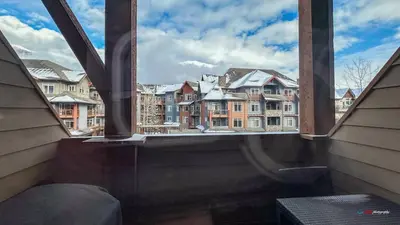 an open window with a view of a city at Solara Suite with Indoor Pool / Hot tub / Parking in Canmore