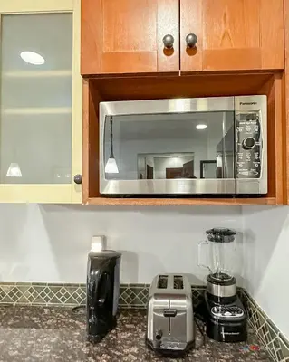 a kitchen counter with a blender and a microwave at Solara Suite with Indoor Pool / Hot tub / Parking in Canmore