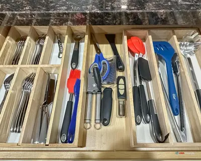 a drawer filled with knives and other kitchen utensils at Solara Suite with Indoor Pool / Hot tub / Parking in Canmore