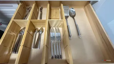 a wooden drawer with silver utensils in it at Solara Suite with Indoor Pool / Hot tub / Parking in Canmore