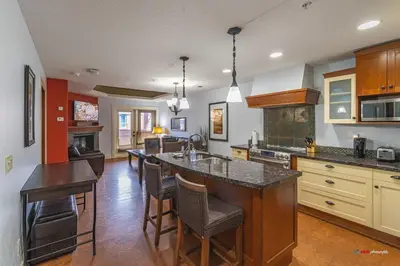 a kitchen with a large island in the middle at Solara Suite with Indoor Pool / Hot tub / Parking in Canmore