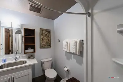a bathroom with a toilet and a sink and a shower at Solara Studio with Pool/Hot tub/Parking/Gym in Canmore