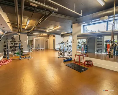 a large room with a gym with bikes in it at Solara Studio with Pool/Hot tub/Parking/Gym in Canmore