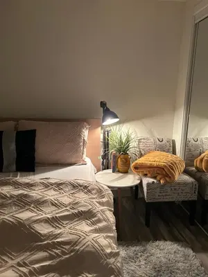 a bedroom with a bed and a table and a chair at Cozy Haven! in Edmonton